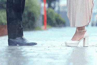 a man and a woman are kissing in the rain