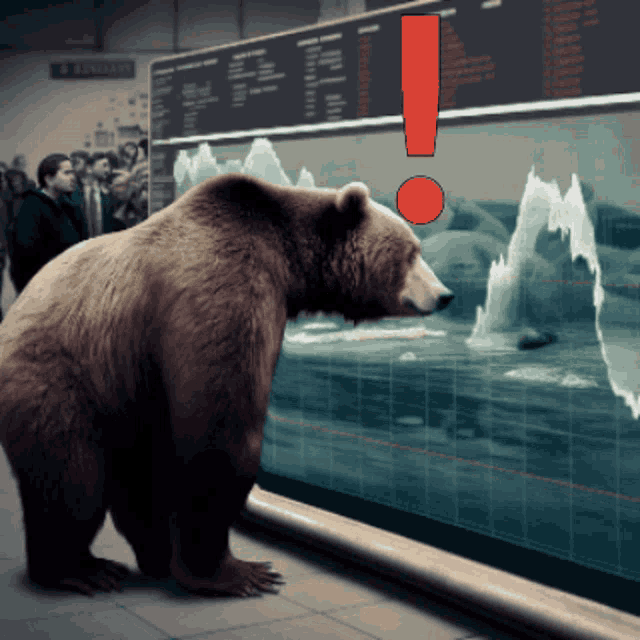a bear is looking at a screen with a red exclamation point above it