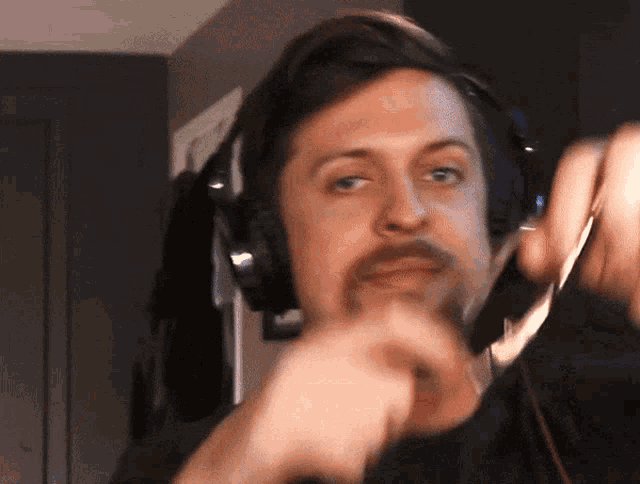 a man with a beard wearing headphones and a microphone