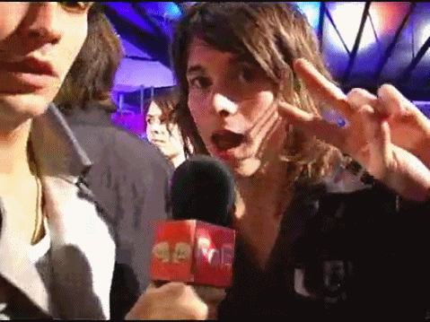 a woman is holding a microphone that says gone on it