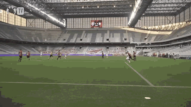 a soccer game is being played in an empty stadium with a tv advertisement