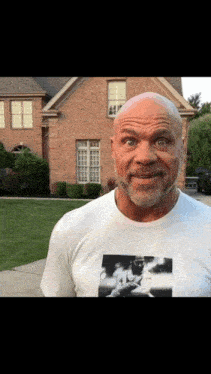 a bald man with a beard wearing a t-shirt with a picture of a man on it
