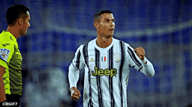 a soccer player wearing a jeep jersey stands next to another player
