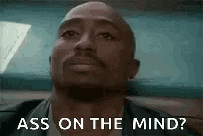 a man with a beard is sitting in a car and says `` ass on the mind ? ''