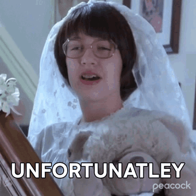 a woman in a wedding dress and veil is holding a teddy bear and making a funny face .
