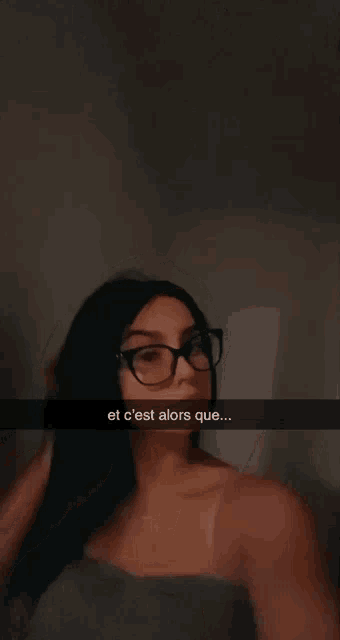 a woman wearing glasses is taking a selfie with the caption " et c'est alors que ... "