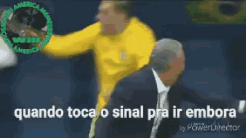 a man in a yellow shirt is being escorted by a man in a suit and tie .