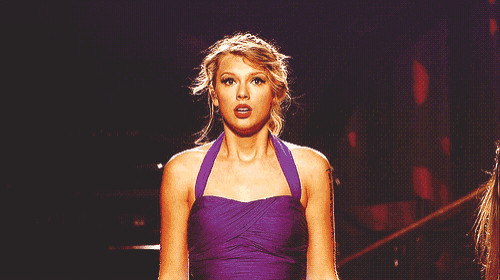 a woman in a purple dress looks surprised