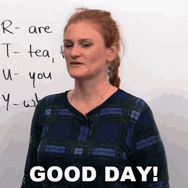 a woman is standing in front of a whiteboard with the words good day written on it