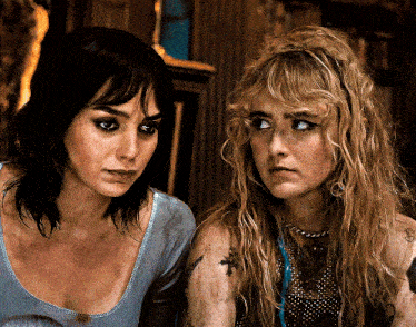 two women with tattoos on their arms are looking at the camera