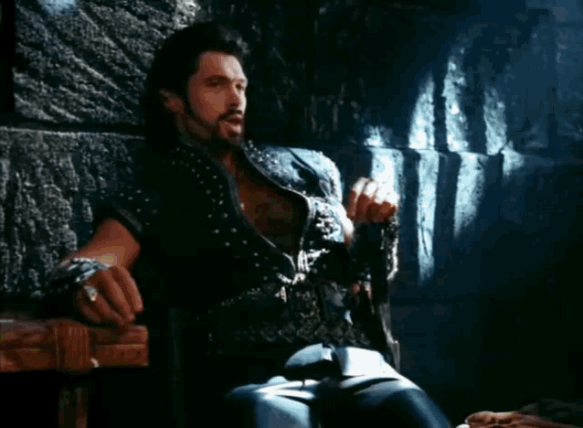 a man sitting in a chair with the words think of the fun i 'll have