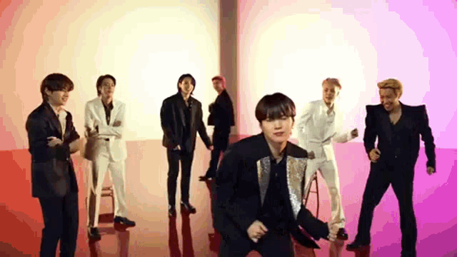 a group of men are standing next to each other in a room .