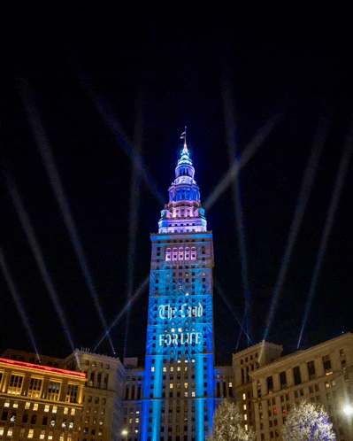 a tall building with the words " the field for life " projected onto it