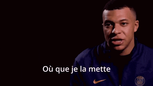 a man wearing a purple nike shirt with the words ouais il va pas la chercher on the bottom