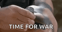 a person is holding a watch in their hand with the words `` time for war '' written below it .