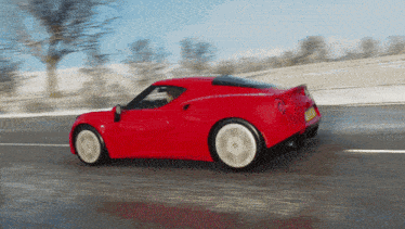 a red sports car is driving down a snowy road with a license plate that says ' aoa ' on it