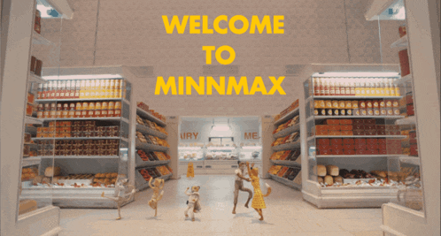 a group of people are dancing in front of a sign that says " welcome to minnmax "