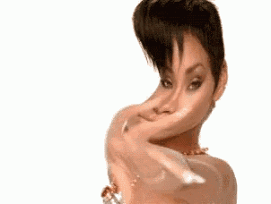 a woman with short hair is pointing at the camera with her finger .