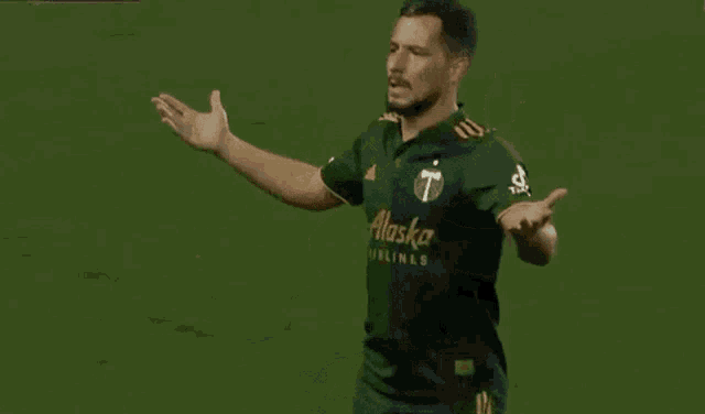 a group of soccer players are hugging each other on a green field .