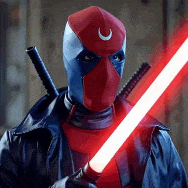a man in a deadpool mask is holding a red light saber