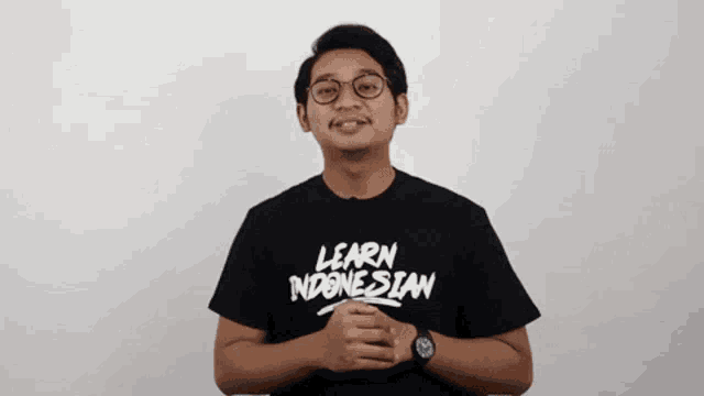 a man wearing a black t-shirt that says learn indonesian