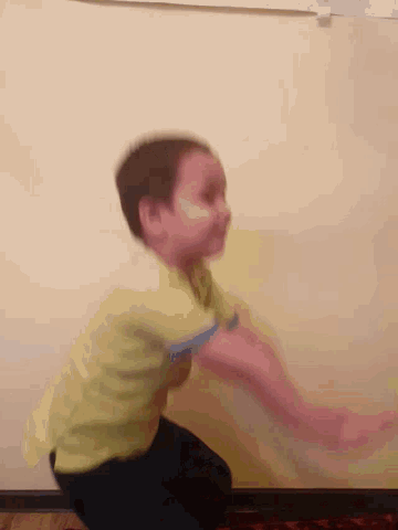 a blurry picture of a person 's face and arms against a wall