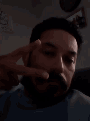 a man with a beard is making a funny face