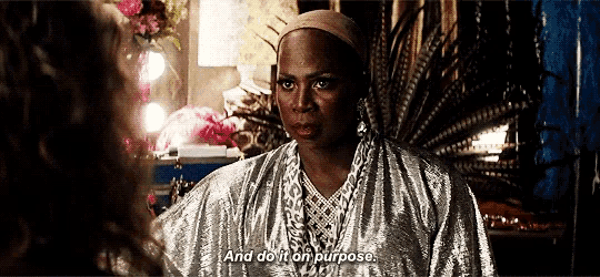 a woman in a silver robe is talking to another woman and says " and do it on purpose "