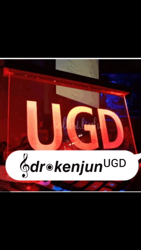 a sign that says ugd and drokenjun ugd on it