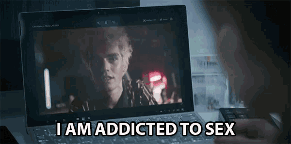a person watching a movie on a laptop with the words i am addicted to sex on the screen