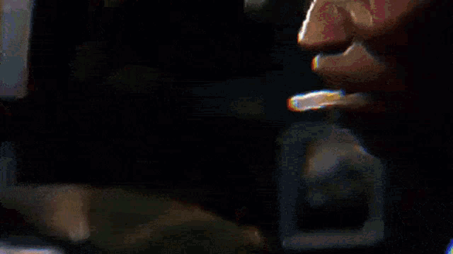 a close up of a person playing a drum set in a dark room