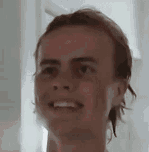 a close up of a person 's face with a funny face .