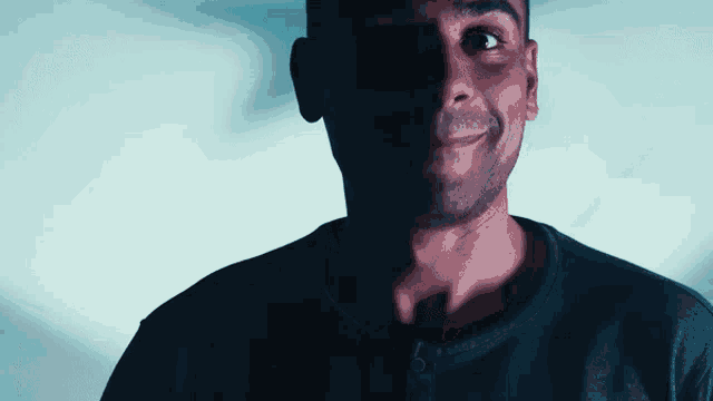 a close up of a man 's face with a blue background