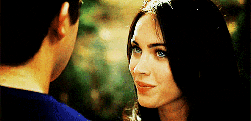 a man and a woman are looking at each other . the woman has blue eyes .
