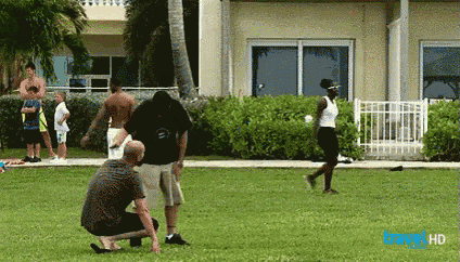a group of people are playing a game of frisbee on a lush green field sponsored by verizon
