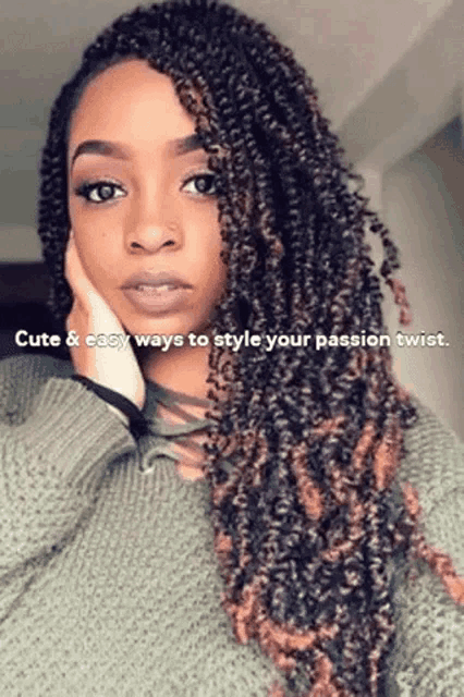 a woman wearing a green sweater has a passion twist in her hair .