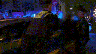 a blurry picture of a man in a yellow vest that says ' ambulance ' on it
