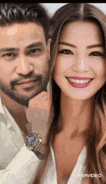 a man and a woman are posing for a picture together and the woman is smiling .