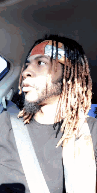 a man with dreadlocks is wearing a headband that says ' i love you ' on it