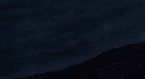 a bunch of lights are floating in the air on a dark background