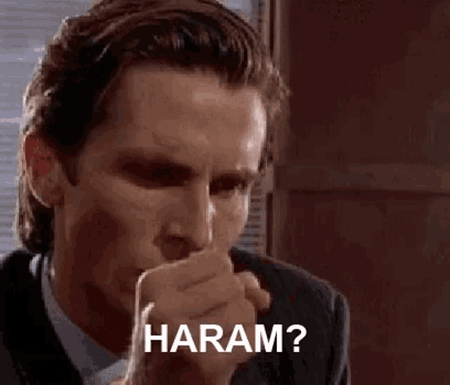 a man in a suit is holding a piece of paper in his hand and says `` haram ? ''