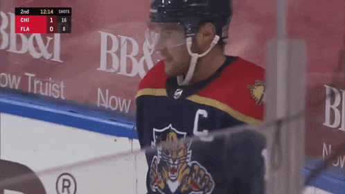 a hockey player wearing a jersey with the letter c on the front