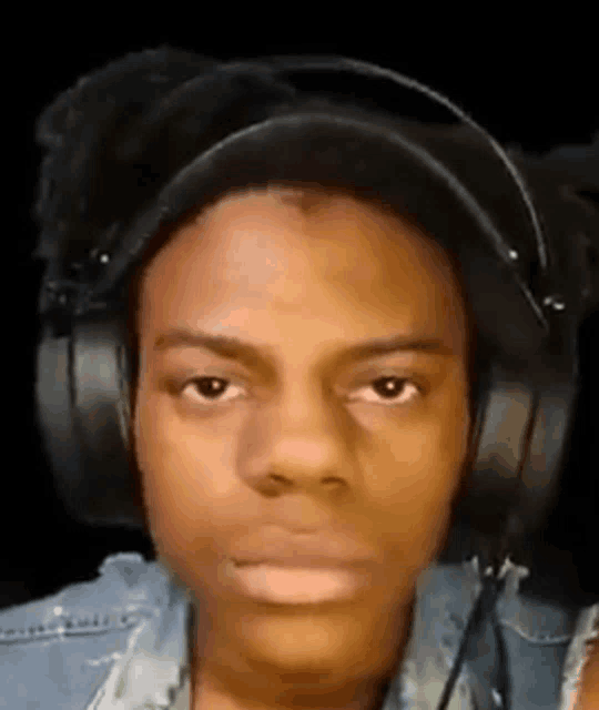 a close up of a person wearing headphones on a black background