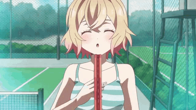 a girl in a striped tank top is holding a racket