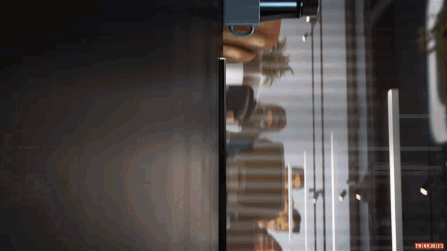 a reflection of a person in a glass door with the words traina fries below it