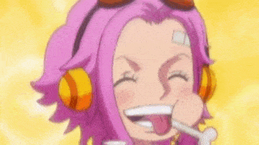 a girl with pink hair and headphones is laughing with her tongue out .