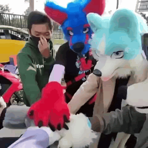 a group of people wearing furry costumes are standing next to each other in a parking lot .