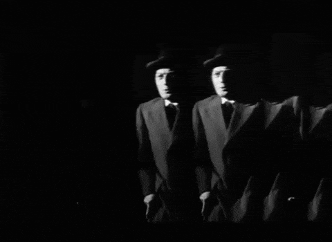 a group of men in suits and hats are standing in a line