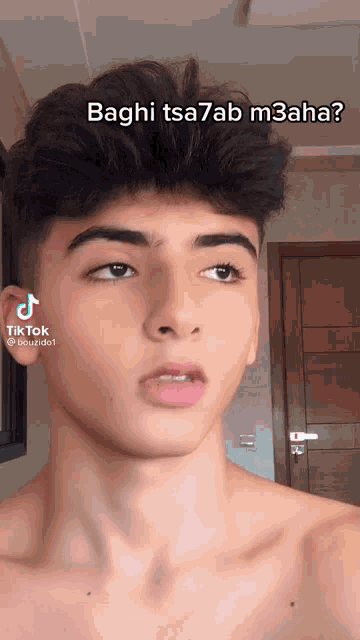 a young man without a shirt is looking at the camera with a tiktok sticker on his face