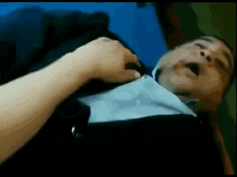 a man in a suit is being attacked by another man